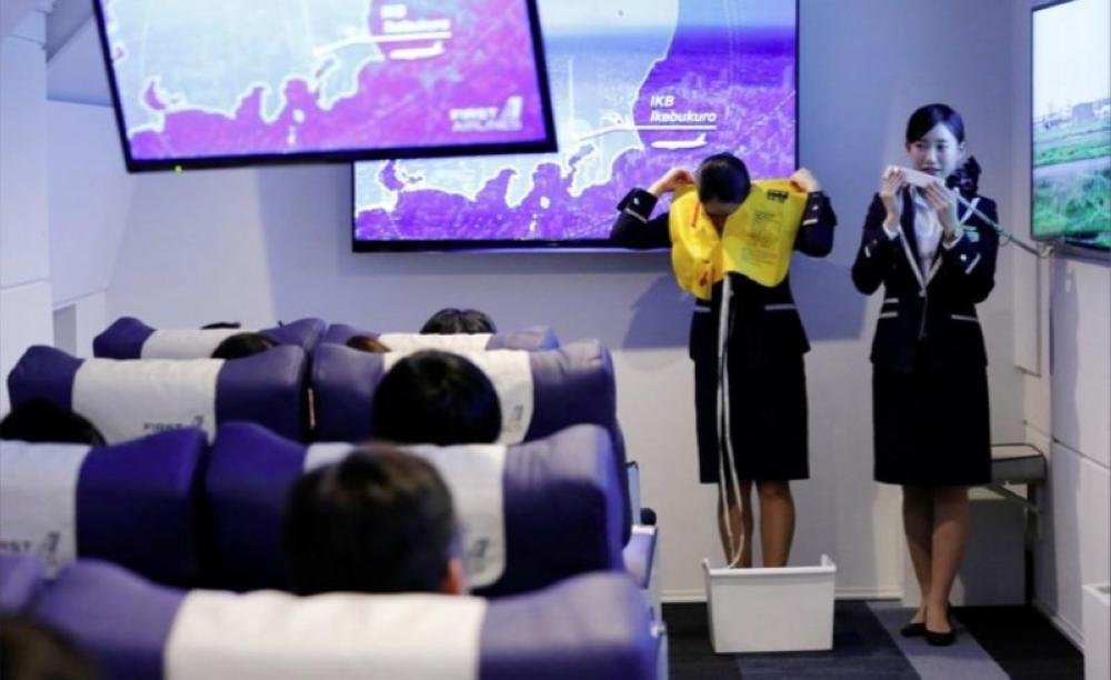 Staff dressed as flight attendants. work at the ‘First Airlines’, virtual first-class airline experience facility in Tokyo on Wednesday. — Reuters