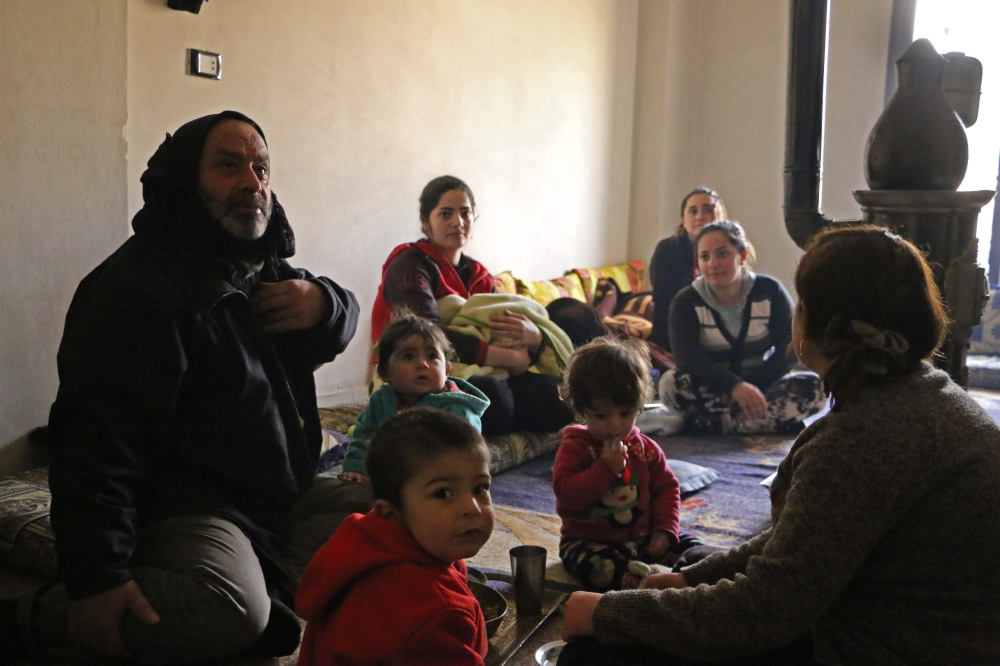 Members of seven displaced Syrian families gather in an apartment in the Kurdish Syrian town of Afrin where they are all taking shelter after fleeing from a three-week assault by Turkey and allied Syrian rebels on towns and villages along the border in northern Syria. The United Nations estimates that between 15,000 to 30,000 have been displaced by the Turkish-led offensive to other parts of Afrin district.  — AFP photos