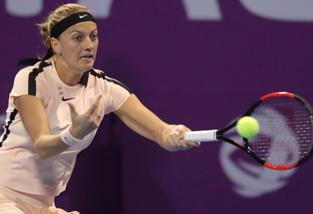 Simona Halep of Romania returns the ball to Catherine Bellis of the US (unseen) as they compete in their singles match during the quarter-final round of the Qatar Open tennis competition in Doha on Friday. — AFP