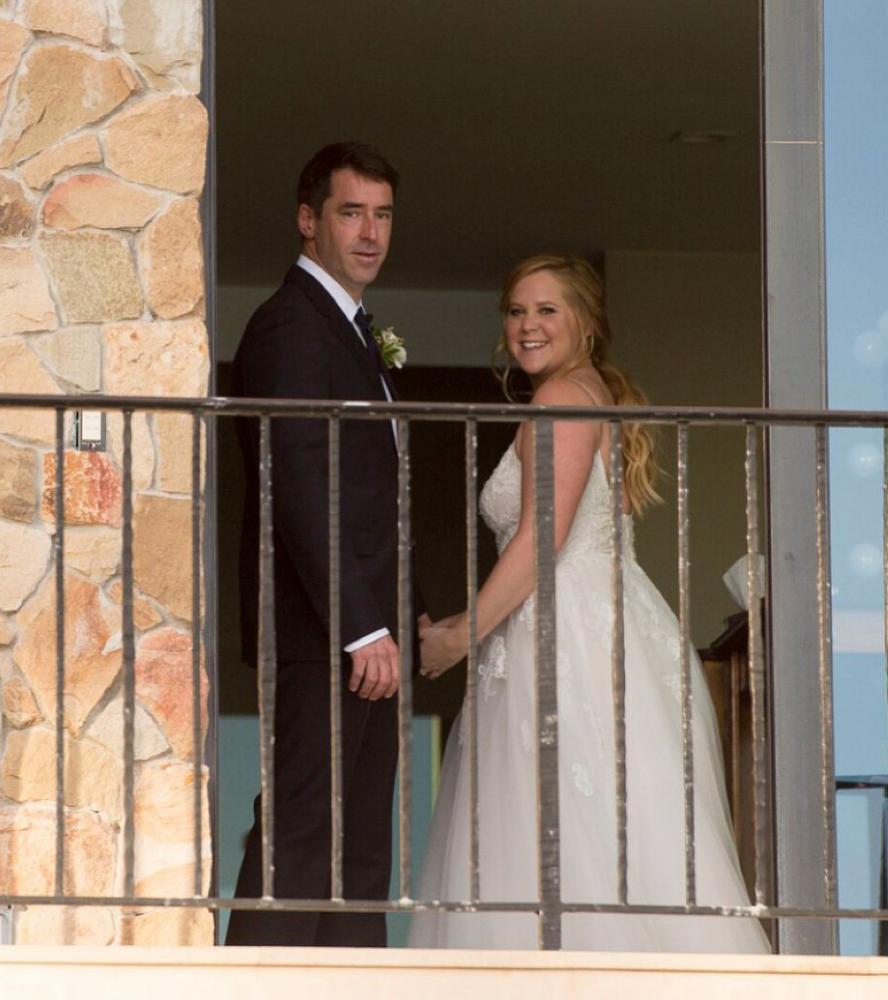 Amy Schumer and Chris Fischer pose after their wedding ceremony in Malibu, California.