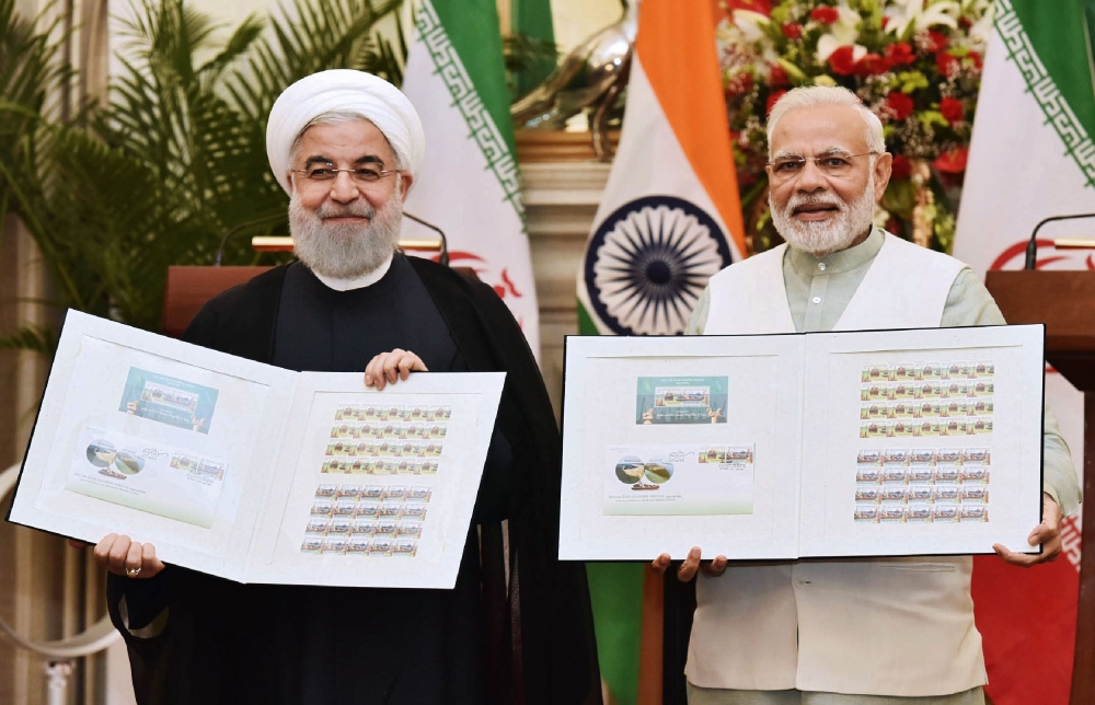 Indian Prime Minister Narendra Modi, right,  and Iranian President Hassan Rouhani release the commemorative stamp celebrating India-Iran relations at Hyderabad House in New Delhi on Saturday. — AFP
