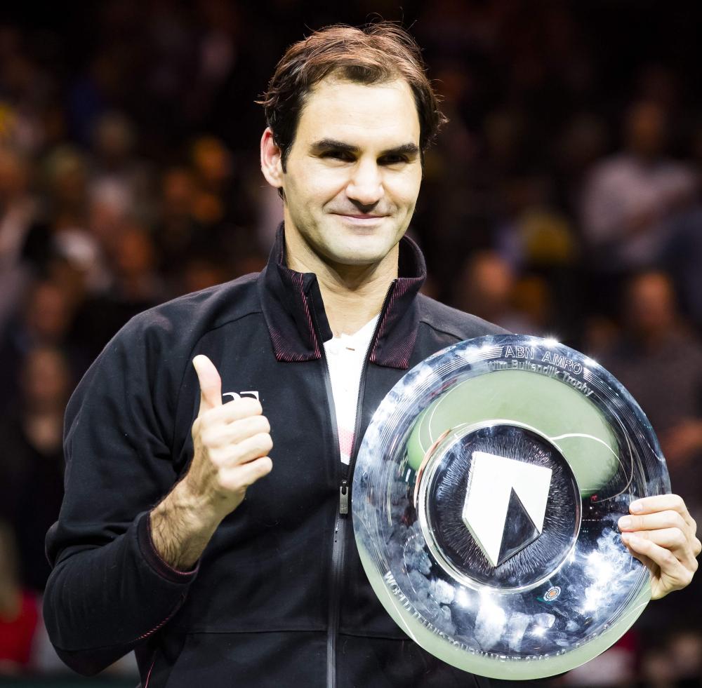 Switzerland's Roger Federer holds his trophy after winning the final against Bulgary's Grigor Dimitrov at the ABN AMRO World Tennis Tournament in Rotterdam Sunday. — AFP