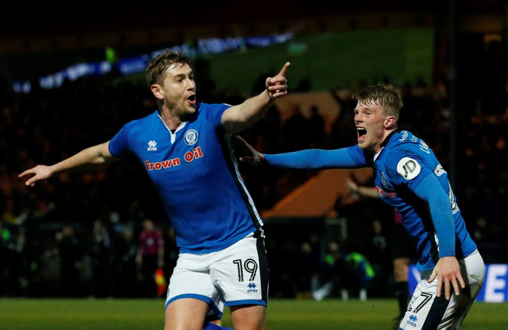Rochdale's Steven Davies celebrates scoring their second goal with Andy Cannon against Tottenham Hotspur during their FA Cup match at The Crown Oil Arena, Rochdale, Britain, Sunday. — Reuters