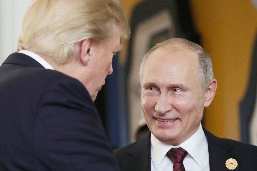 US President Donald Trump, left, chats with Russian President Vladimir Putin as they attend the APEC Economic Leaders Meeting, part of the Asia-Pacific Economic Cooperation (APEC) leaders summit in the central Vietnamese city of Danang in this Nov. 11, 2017 file photo. — AFP