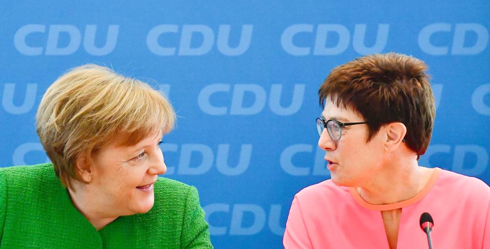 German Chancellor Angela Merkel, left, and the State Premier of Saarland Annegret Kramp-Karrenbauer talk ahead of a leadership meeting of their Christian Democrats Party (CDU),  at the CDU headquarters in Berlin on Monday. — AFP