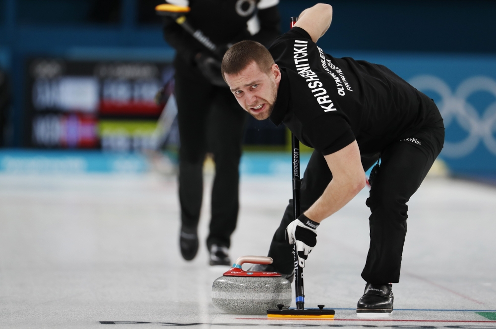 Alexander Krushelnitsky, an Olympic athlete from Russia, sweeps, during the Mixed Doubles Bronze Medal curling clash between Olympic Athletes from Russia and Norway at Gangneung Curling Center. — Reuters