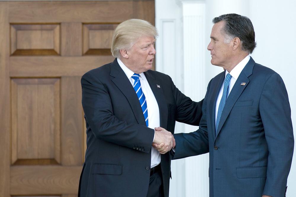 President Donald Trump shakes hands with Mitt Romney after their meeting at Trump International Golf Club in Bedminster Township, New Jersey, in this Nov. 19, 2016 file photo. — AFP