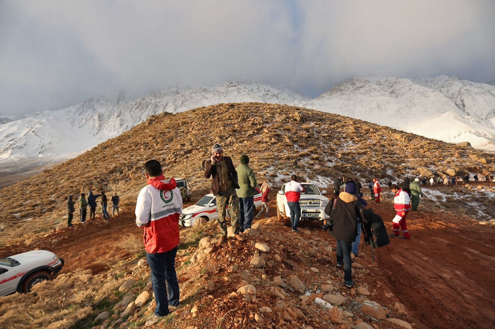 Members of a rescue team searching for the wreckage of Aseman Airlines flight EP3704 in Iran's Zagros mountain range. — AFP