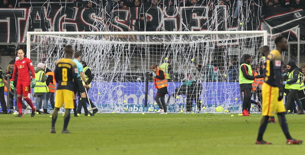 Fans throw tennis balls on the pitch as they protest against scheduling football games on Mondays (Montagsspiele) during the German  Bundesliga football match between Eintracht Frankfurt and RB Leipzig in Frankfurt, Germany, on Monday. — AFP