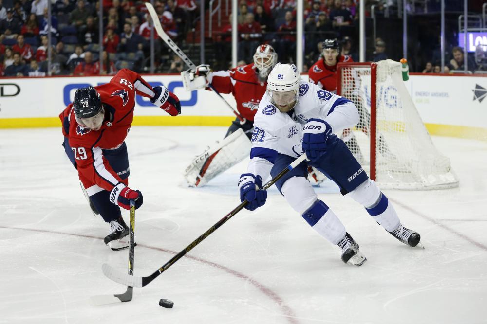 Tampa Bay Lightning’s center Steven Stamkos (R) battles for the puck with Washington Capitals’ defenseman Christian Djoos during their NHL game at Capital One Arena in Washington Tuesday. — Reuters