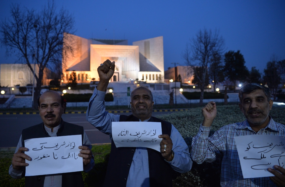 Supporters of ousted Pakistani Prime Minister Nawaz Sharif chant slogans against a court verdict in front of the Supreme Court building in Islamabad on Wednesday. — AFP