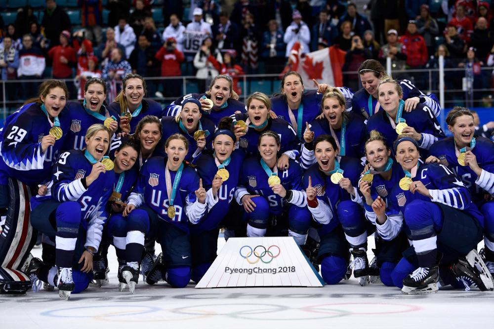 The US women’s ice hockey team poses with gold medals after the medal ceremony at the Pyeongchang 2018 Winter Olympic Games Thursday. — AFP 