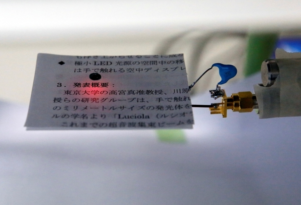 ERATO Kawahara Universal Information Network Project's 'Luciola', miniature floating LED light aptly named after fireflies, lights on written text during its demonstration at the University of Tokyo, Japan. — Reuters