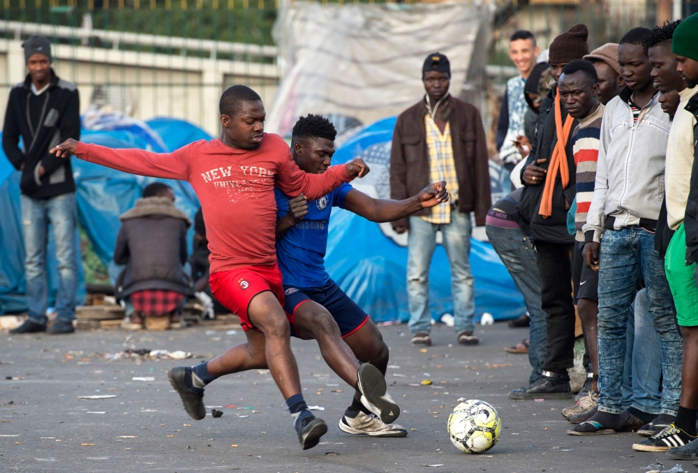 Sub-Saharan migrants play in a football match on a makeshift pitch in the middle of the Oulad Ziane migrant camp in Casablanca.  For the migrants in the Oulad Ziana migrant camp, who dream of one day crossing the Mediterranean to Europe, taking part in football games at the camp is a way to forget the tough situation they are in. — AFP photos
