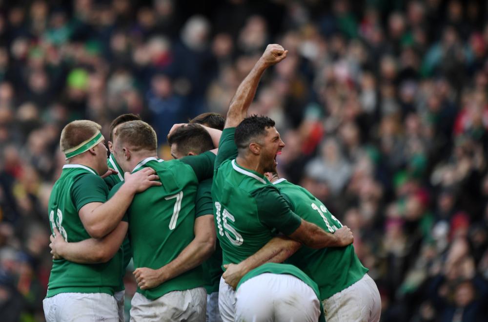 Ireland’s Rob Kearney celebrates with teammates after their fifth try scored against Wales during their Six Nations Championship match at Aviva Stadium, Dublin, Saturday. — Reuters