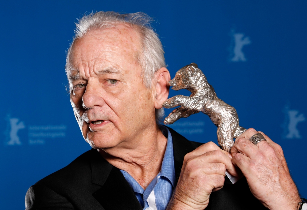 Actor Bill Murray holds the Silver Bear for Best Director award received on behalf of Wes Anderson for the movie 