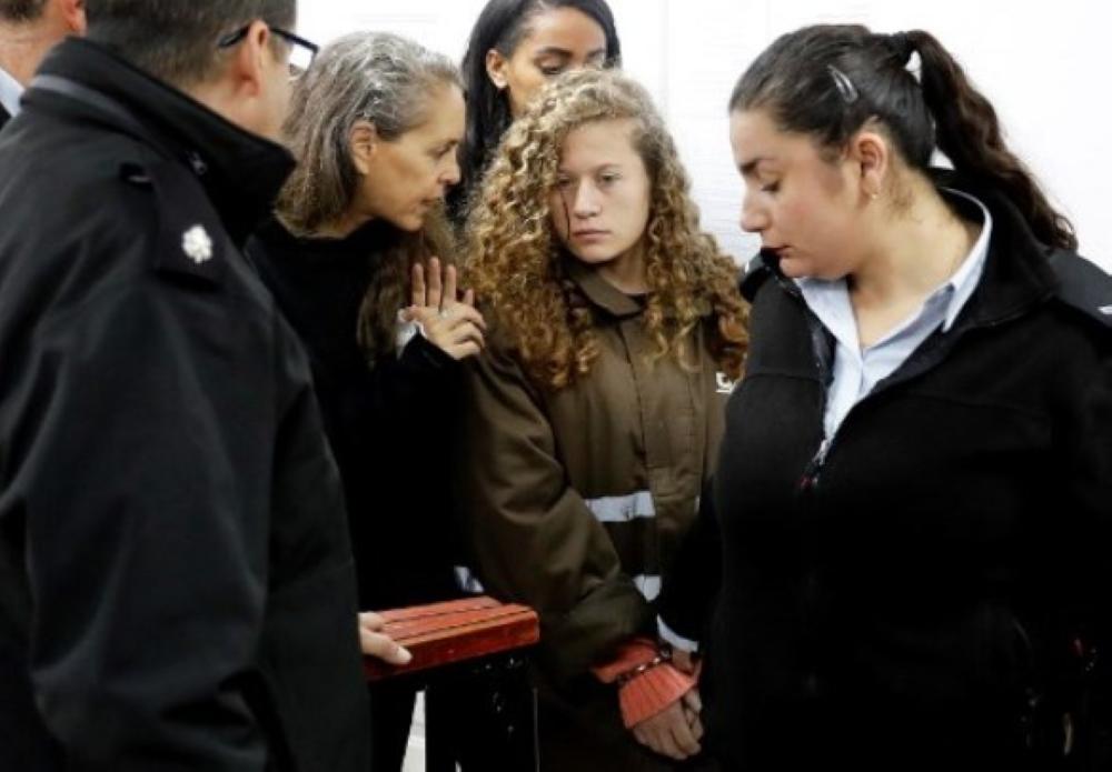 Israeli lawyer Gaby Lasky (C-L) speaks with her client 16-years-old Ahed Tamimi (2R) before she stands for a hearing in the military court at Ofer military prison in the West Bank village of Betunia in this Jan. 1, 2018, file photo. — AFP