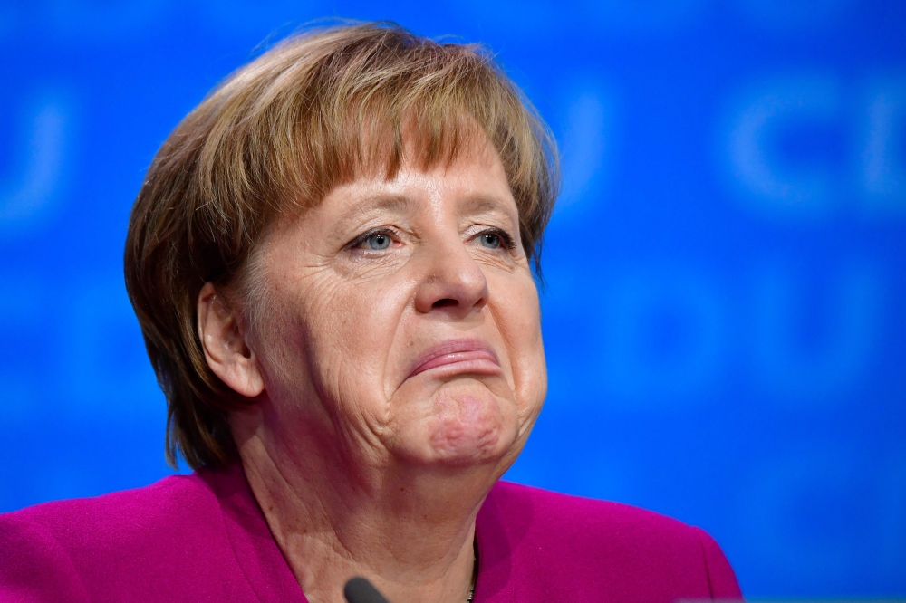 German Chancellor and leader of the Christian Democratic Union (CDU) Angela Merkel reacts during the party congress of the Christian Democratic Union (CDU) in Berlin on Monday. — AFP