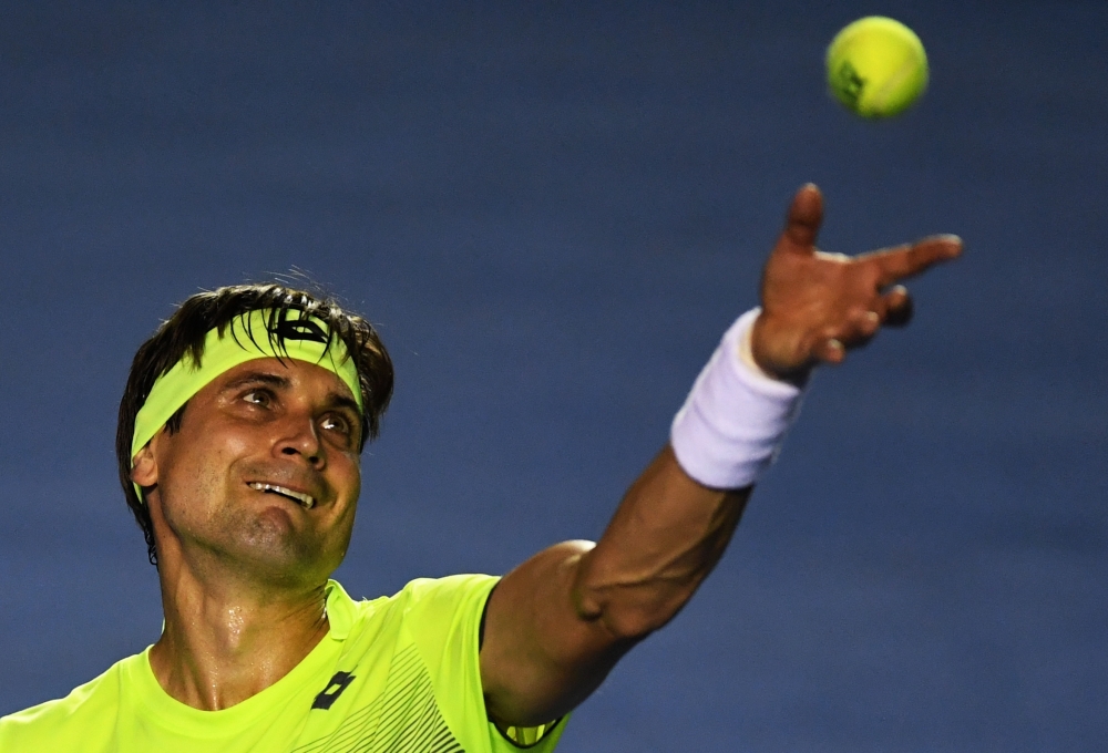 Spain´s David Ferrer serves to Russia's Andrey Rublev (out of frame) during their Mexico ATP 500 Open men's single tennis match in Acapulco, Guerrero state on Monday. — AFP