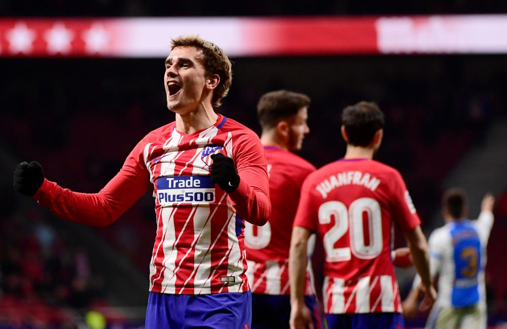 Atletico Madrid’s Antoine Griezmann celebrates his third goal during the Spanish league football match against Deportivo at the Wanda Metropolitano Stadium in Madrid Wednesday. — AFP