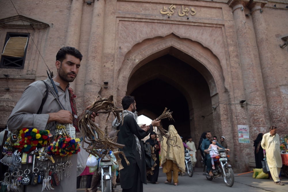 Vendors wait for customers at Delhi Gate in Pakistan's historic and cultural city of Lahore. Lahore, which once served as the capital of the Mogul empire that stretched across much of the subcontinent, has been subsumed into a myriad of civilizations across the centuries. This rich past is most visible in the milieu of architecture salted across the Walled City of Lahore — from Hindu temples and Mogul forts to Sikh gurdwaras and administrative office built during the Raj. — AFP photos