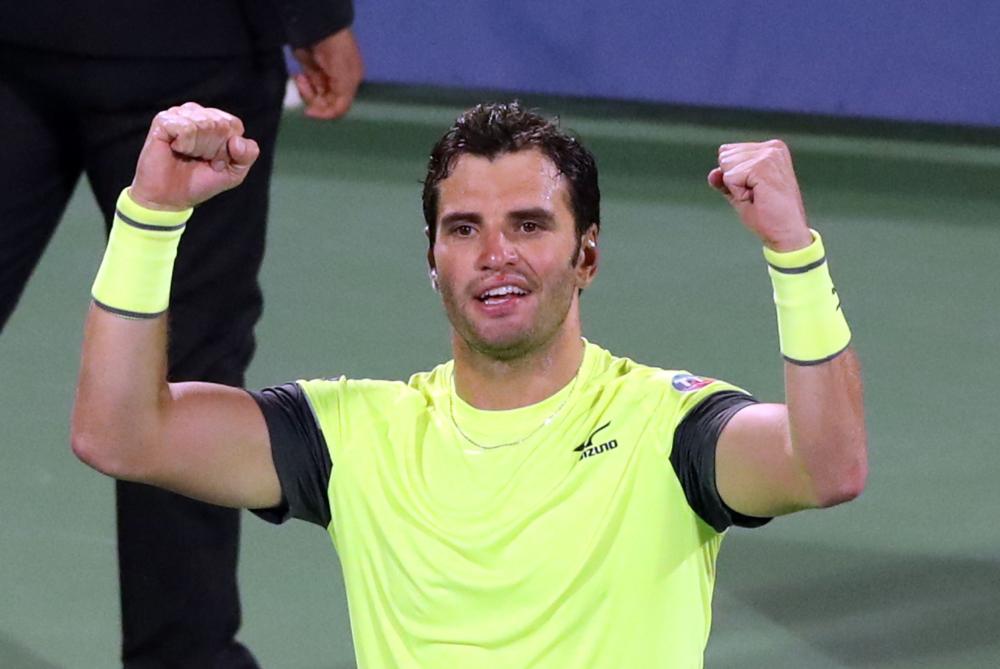 Malek Jaziri of Tunisia celebrates after defeating Stefanos Tsitsipas of Greece in the 2018 ATP Dubai Duty Free Tennis Championships Thursday. — AFP