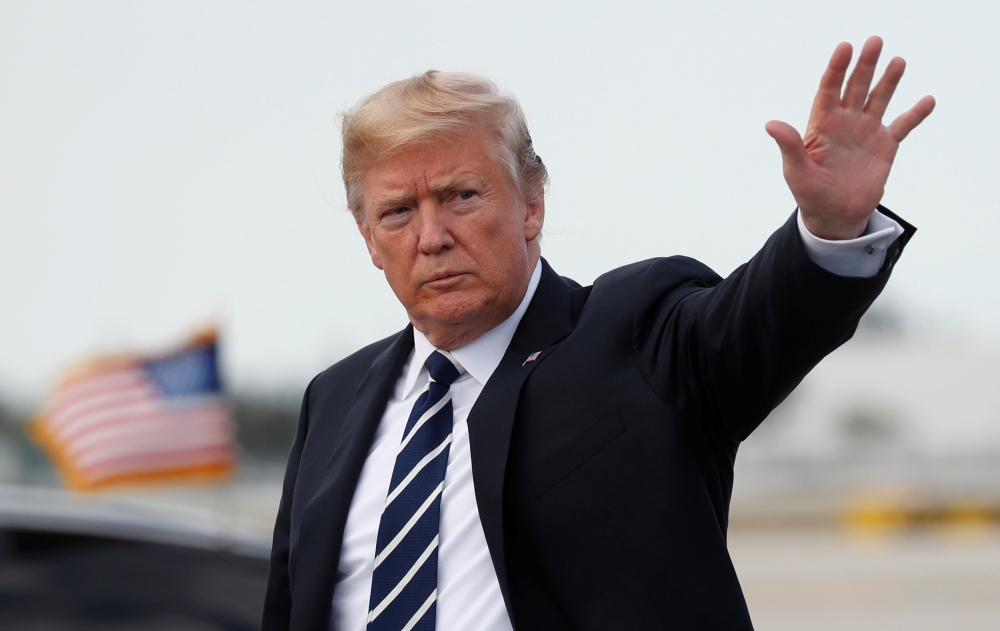 US President Donald Trump waves upon his arrival in West Palm Beach, Florida, on Friday. — Reuters