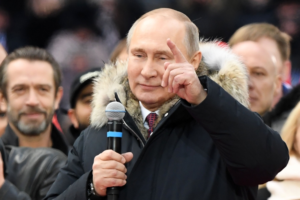  President Vladimir Putin attends a rally to support his candidature in the upcoming presidential election at the Luzhniki stadium in Moscow on Saturday. — AFP