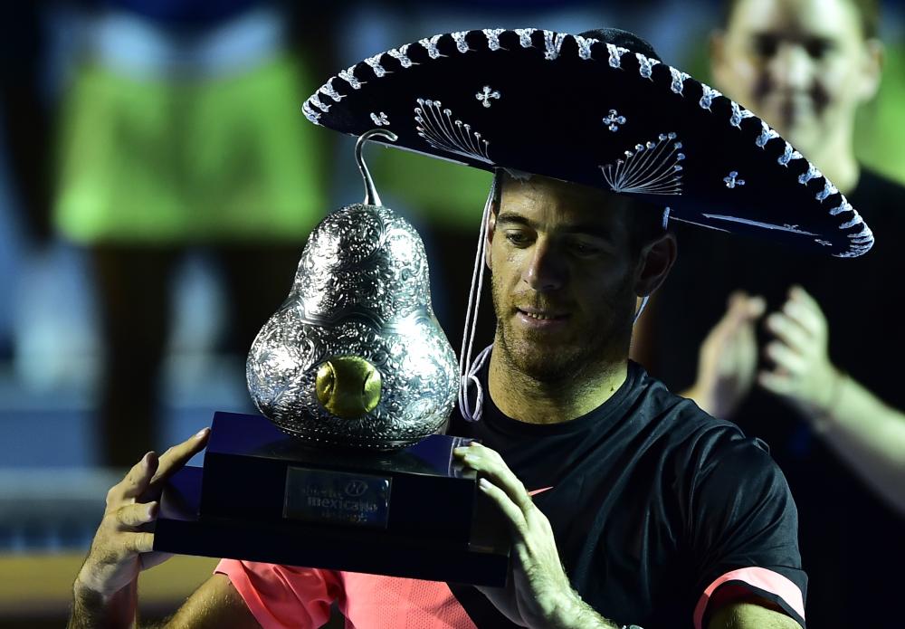 Argentina’s Juan Martin del Potro wears a traditional Mexican mariachi hat while holding the winning trophy in Acapulco, Mexico, Saturday. — AFP