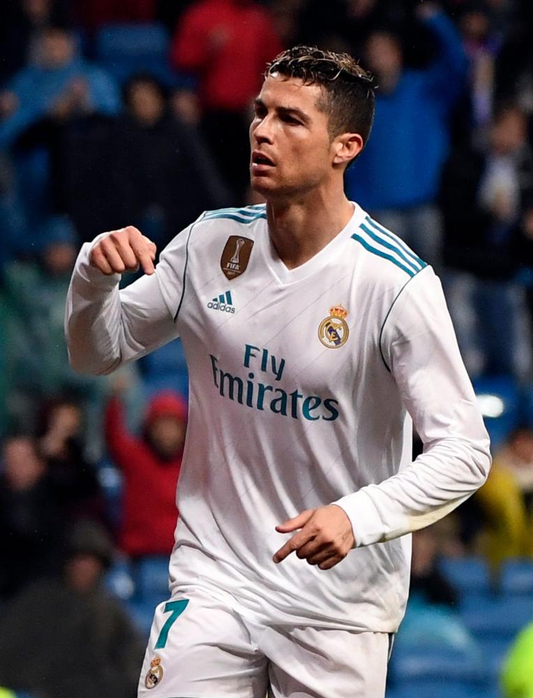 Real Madrid’s Cristiano Ronaldo celebrates his second goal during their Spanish league football match against Getafe at the Santiago Bernabeu Stadium in Madrid Saturday. — AFP