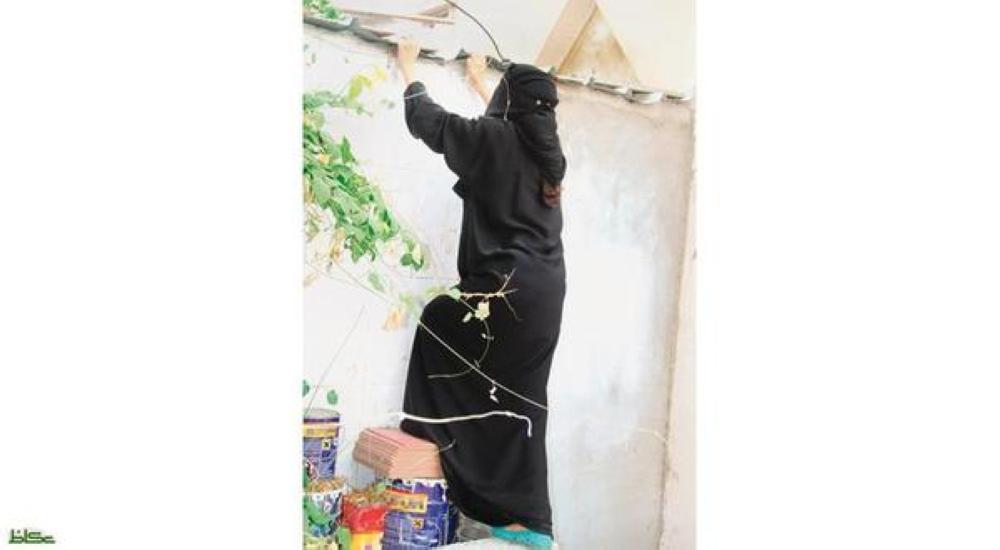 One of the inmates of the Women Hospitality Home in Jeddah tries to climb over a wall in an apparent bid to escape.