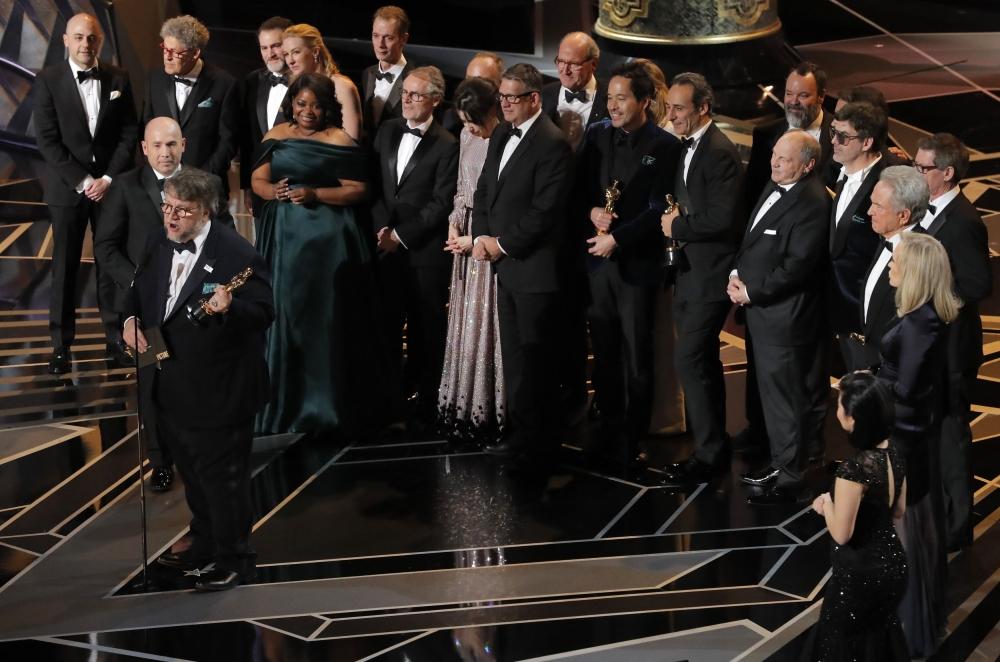 Guillermo del Toro (L) accepts the Oscar for Best Picture for 