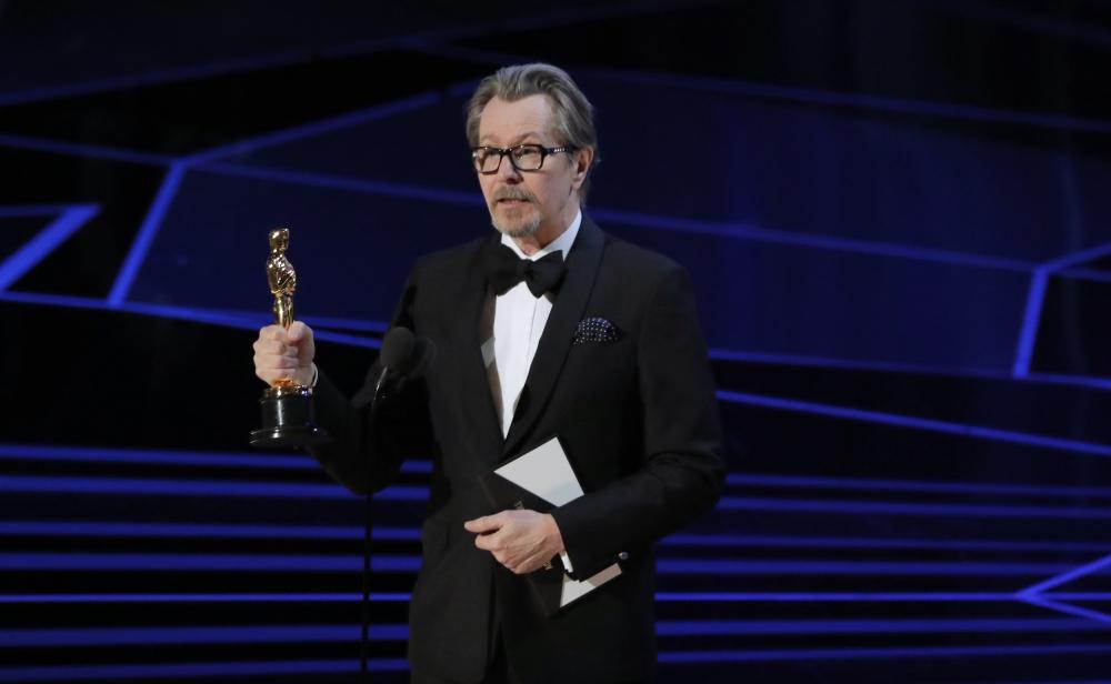 Guillermo del Toro (L) accepts the Oscar for Best Picture for 