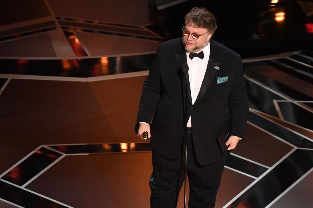 Guillermo del Toro (L) accepts the Oscar for Best Picture for 