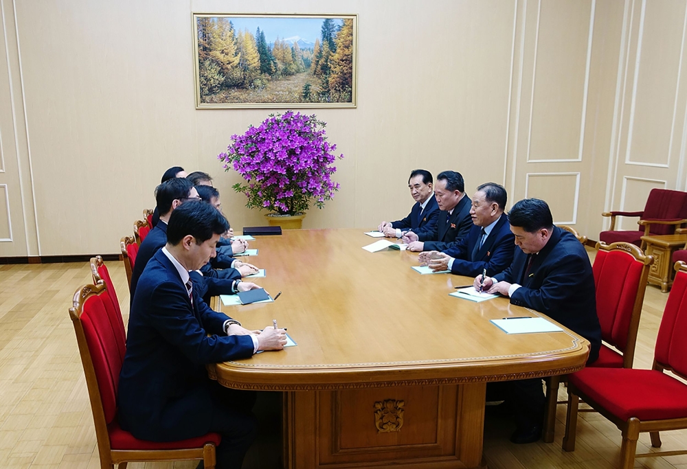 Members of a South Korean delegation, left row, who traveled as envoys of the South’s President Moon Jae-in, talk with General Kim Yong Chol, second right, who is in charge of inter-Korean affairs for North Korea’s ruling Workers’ Party, during their meeting in Pyongyang on Monday.  — AFP
