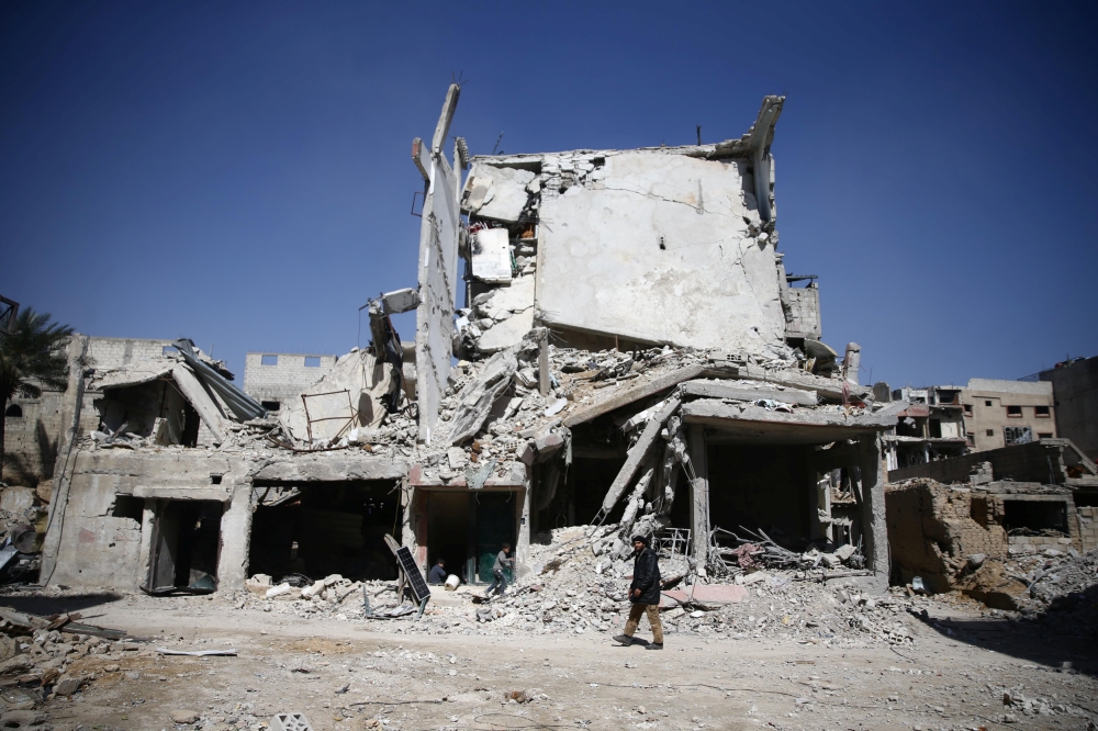 Abu Mohammad Alaya's building is seen damaged in Douma, Syria. — Reuters