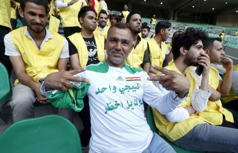 Iraqi supporters watch their team at a training session ahead of a home friendly against Saudi Arabia in Basra on Feb. 28. — AFP