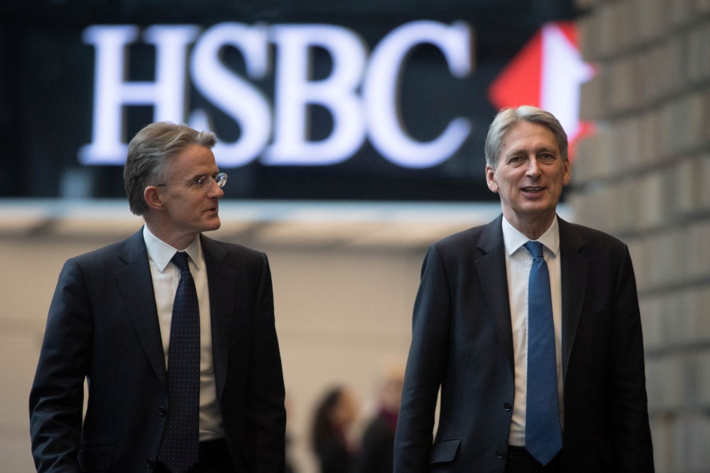 Britain's Finance Minister Philip Hammond, with CEO John Flint, arrives at HSBC to deliver a speech on Brexit at their headquarters in Canary Wharf in London, Britain. — Reuters