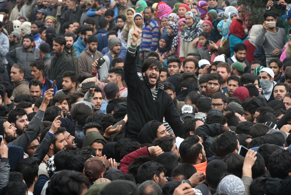 Kashmiri mourners shout pro-freedom slogans during the funeral precession of militant Eisa Fazili in Srinagar on Monday. — AFP