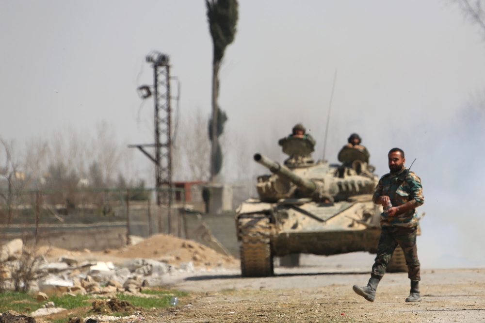 Syrian government forces outside the town of Jisreen in the southern tip of the rebel-held Eastern Ghouta enclave as they advance in the area. Defying global calls for a ceasefire, Syria's government has pursued a ferocious Russian-backed air campaign and ground offensive to capture the region. — AFP