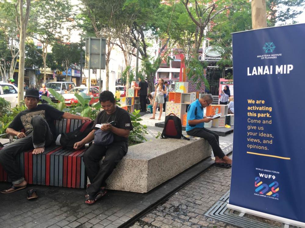 In Kuala Lumpur's bustling historic center, local urban regeneration agency Think City installed a pop-up plaza along Petaling Street and three small green spaces, known as parklets. They form a cluster of benches, plants, and overhead canvas for shade taking up the size of a parking spot along the busy street, as well as a mock microhousing unit in an existing park.