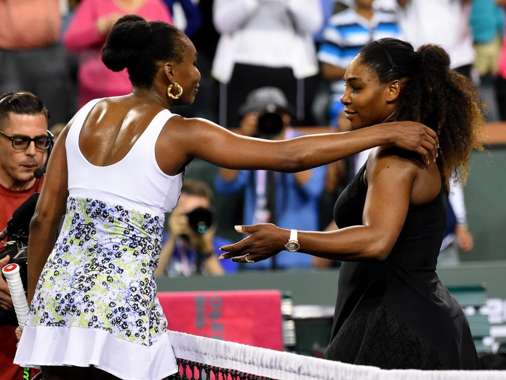 Venus Williams (L) and Serena Williams hug after their third round match in the BNP Paribas Open at the Indian Wells Tennis Garden Monday. — Reuters