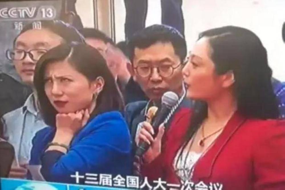 This screengrab shows Liang Xiangyi rolling her eyes while a fellow reporter is busy introducing herself during China's annual Parliament session in Beijing on Wednesday. 