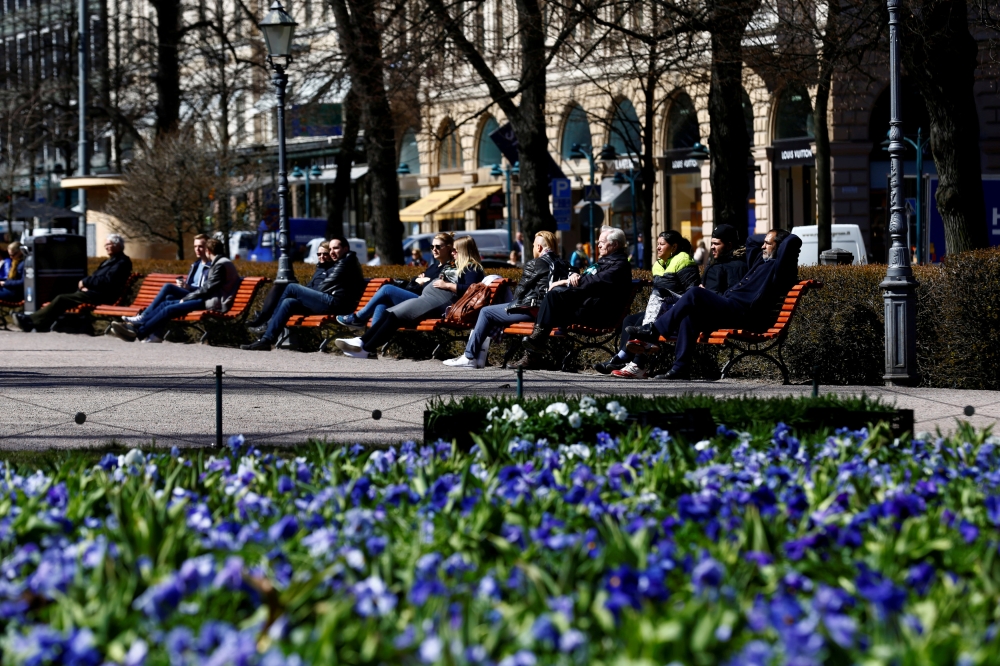 People enjoy a sunny day at the Esplanade in Helsinki, Finland, in this May 3, 2017 file photo. — Reuters