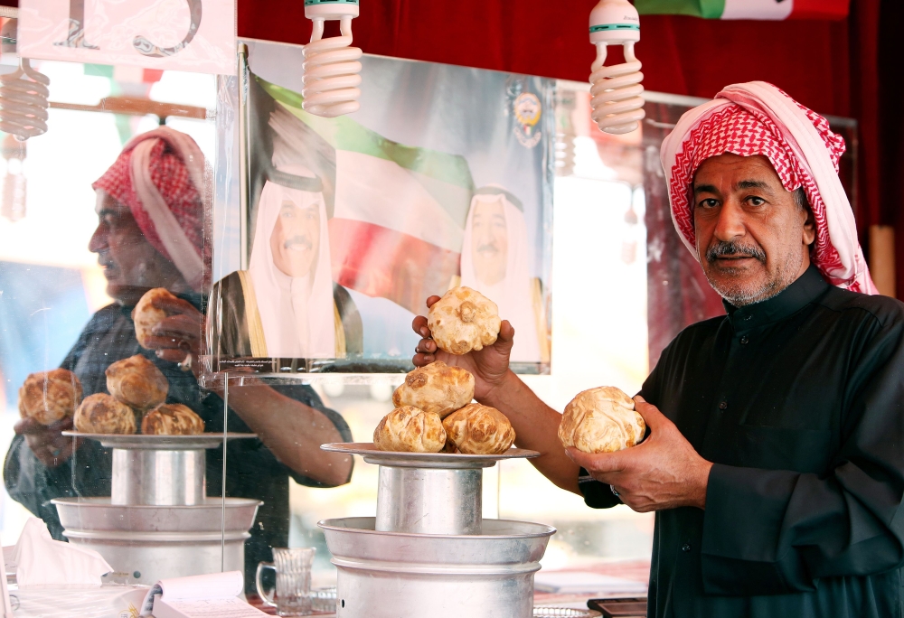 A Kuwaiti vendor stands behind his truffles for sale at a market in Al-Rai, an industrial zone northwest of Kuwait City in this March 1, 2018 file photo. — AFP