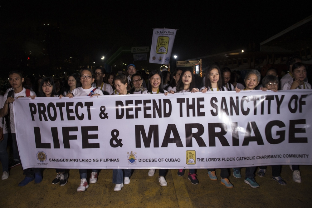 Philippine Catholic faithful hold a banner as they take part in a “Walk for Life” protest at a park in Manila in this February 24, 2018 file photo. — AFP