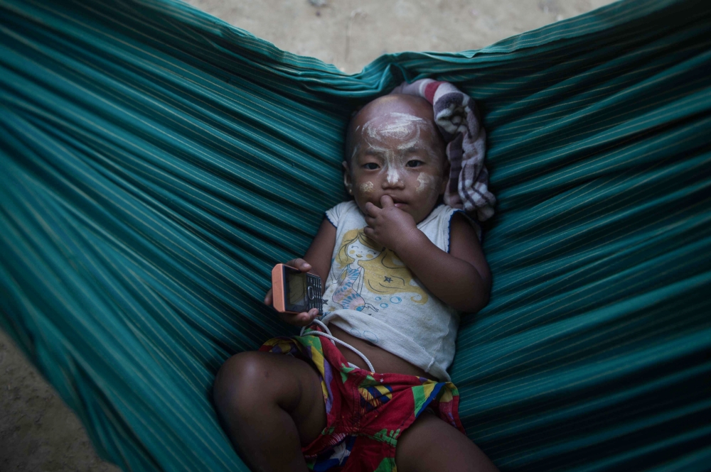 A Rakhine baby lies in a cradle in Koe Tan Kauk village, Rathedaung township in Myanmar’s Rakhine State, in this March 8, 2018 file photo. — AFP