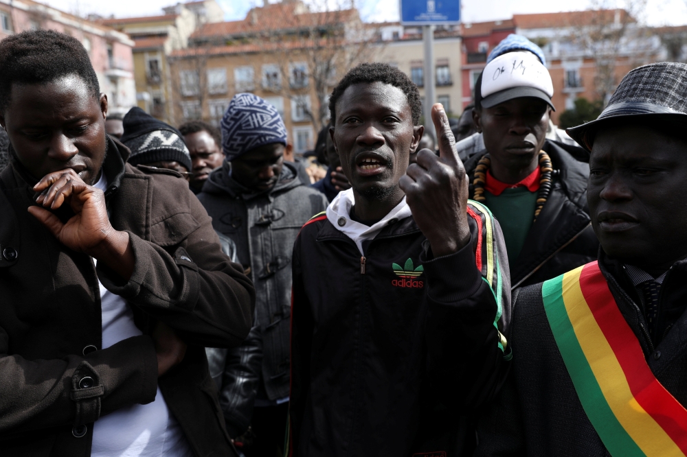 People speak out during a gathering to protest the death of a street hawker in central Madrid, Spain, on Friday. — Reuters