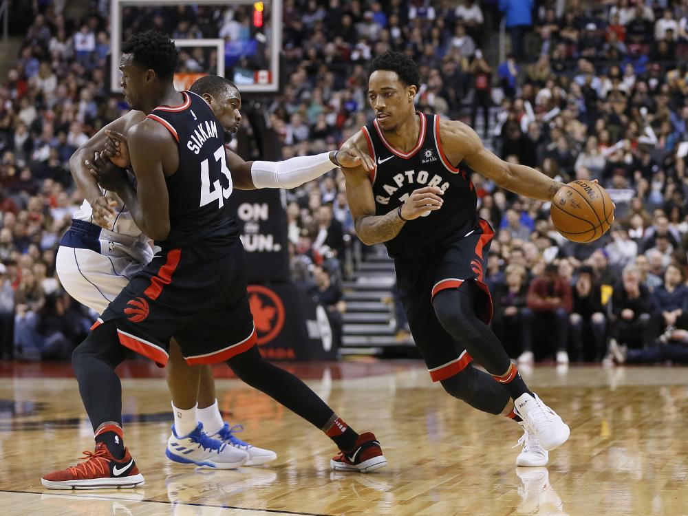 Toronto Raptors’ guard DeMar DeRozan drives to the basket as forward Pascal Siakam screens a Dallas Mavericks’ player at the Air Canada Centre in Toronto Friday. — Reuters