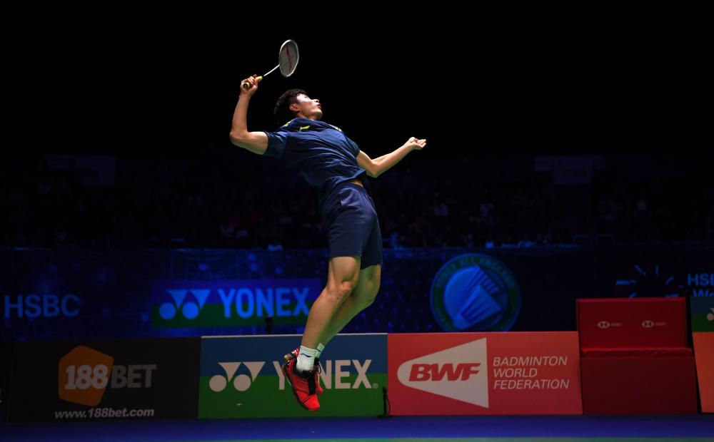 China’s Shi Yuqi leaps for a return against South Korea’s Son Wan Ho during their semifinal match at the All England Open Badminton Championships in Birmingham Saturday. — AFP